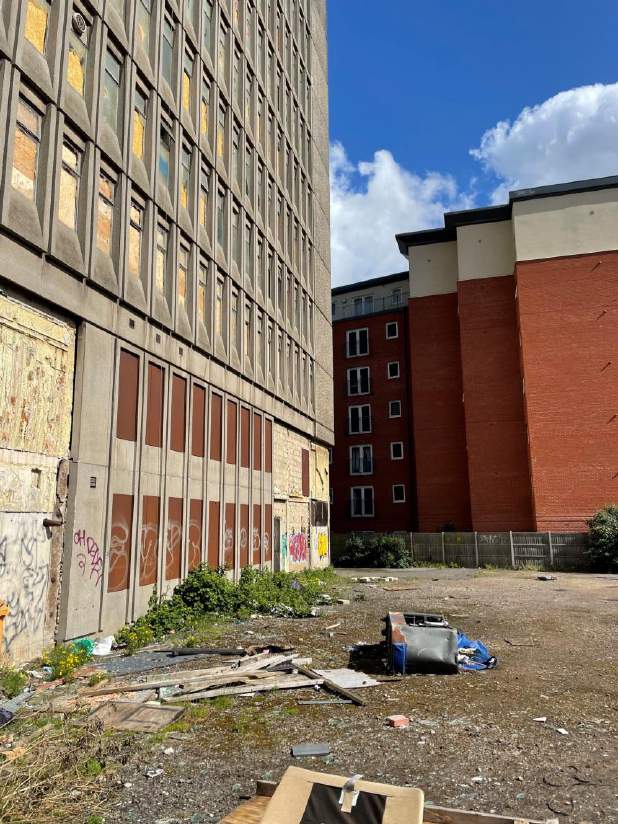 Existing Crown House at street level with neighbouring buildings — photograph