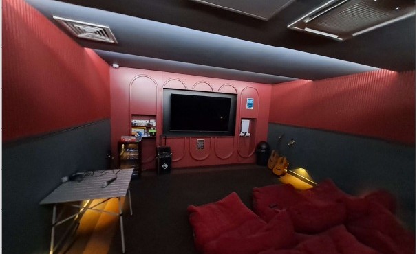 Cinema room with large screen and soft seating